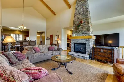 a living room with a couch and a fireplace at 1 Mi to Granby Ranch Mtn Home with Deck in Granby