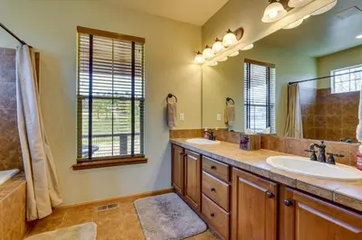 a bathroom with two sinks and a large mirror at 1 Mi to Granby Ranch Mtn Home with Deck in Granby