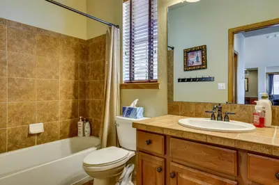 a bathroom with a toilet and a sink and a tub at 1 Mi to Granby Ranch Mtn Home with Deck in Granby