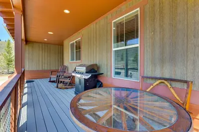 a porch with a glass table on a deck at 1 Mi to Granby Ranch Mtn Home with Deck in Granby