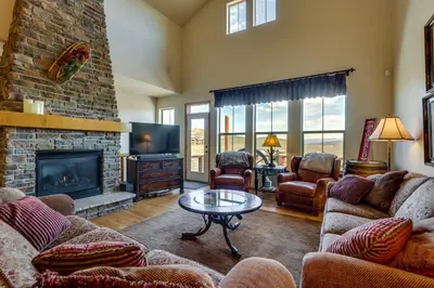 a living room with couches and a fireplace at 1 Mi to Granby Ranch Mtn Home with Deck in Granby