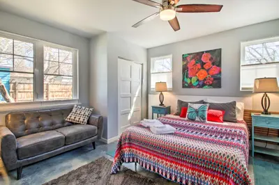 a bedroom with a bed and a couch at Fort Collins Vacation Rental with Private Hot Tub! in Fort Collins