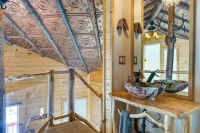 a bathroom with two sinks and a mirror at Idaho Springs Cabin with Hot Tub on Half Acre! in Idaho Springs