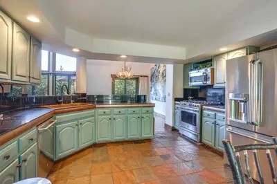 a large kitchen with green cabinets and stainless steel appliances at 11 Mi to Slopes Frisco Home with Hot Tub and Sauna! in Frisco