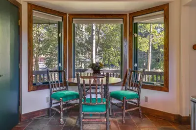 a dining room with a table and chairs and windows at 11 Mi to Slopes Frisco Home with Hot Tub and Sauna! in Frisco