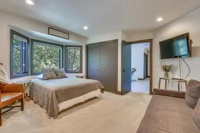 a bedroom with a bed and a flat screen tv at 11 Mi to Slopes Frisco Home with Hot Tub and Sauna! in Frisco