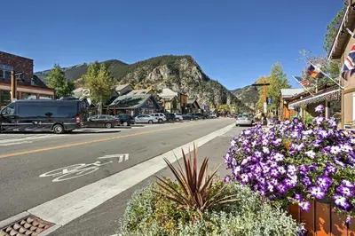 a street in a town with purple flowers and mountains at 11 Mi to Slopes Frisco Home with Hot Tub and Sauna! in Frisco