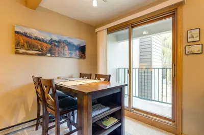 a dining room with a table and a window at Winter Park Ski-InandSki-Out Condo with Mountain Views in Winter Park
