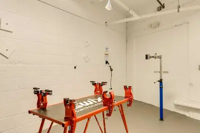 a room with two red chainsaws on a bench at Winter Park Ski-InandSki-Out Condo with Mountain Views in Winter Park
