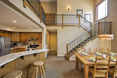 a kitchen and dining room with a wooden table at Half-Mi to Copper Mtn Slopes Frisco Unit with Loft in Frisco
