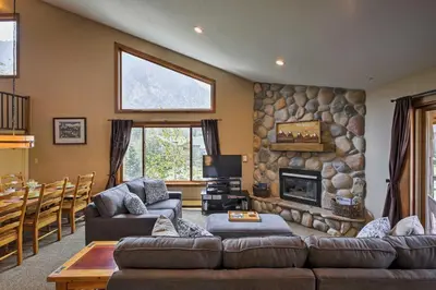 a living room with couches and a stone fireplace at Half-Mi to Copper Mtn Slopes Frisco Unit with Loft in Frisco