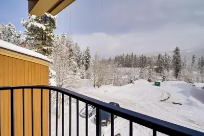 a balcony with snow on the ground and trees at Winter Park Condo with Hot Tubs, 4 Mi to Ski Resort! in Winter Park