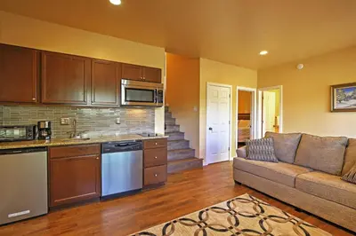 a living room with a couch and a kitchen at 7 Mi to Slopes! Mtn-View Silverthorne Resort Hub in Silverthorne