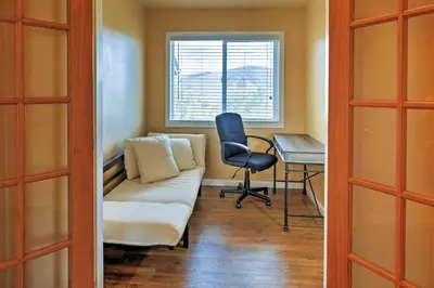 a living room with a couch and a chair and a desk at 7 Mi to Slopes! Mtn-View Silverthorne Resort Hub in Silverthorne