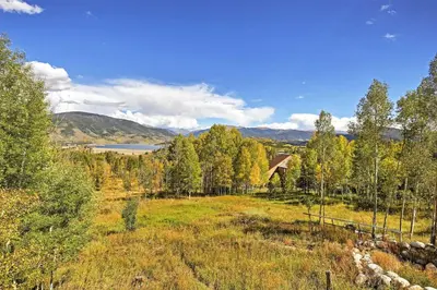 a bridge over a field with trees and a lake at 7 Mi to Slopes! Mtn-View Silverthorne Resort Hub in Silverthorne