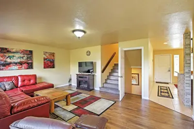a living room with a red couch and a table at 7 Mi to Slopes! Mtn-View Silverthorne Resort Hub in Silverthorne