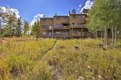 an apartment building on a hill with tall grass at 7 Mi to Slopes! Mtn-View Silverthorne Resort Hub in Silverthorne