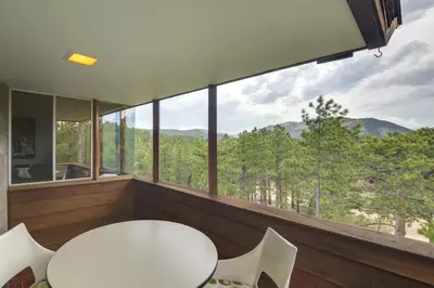a room with a table and chairs and a large window at Boulder Barrett House on Mtn Peak with Hot Tub in Boulder