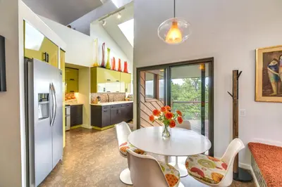 a kitchen and dining room with a white table and chairs at Boulder Barrett House on Mtn Peak with Hot Tub in Boulder