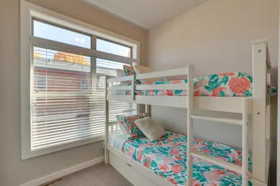 a bedroom with two bunk beds and a window at 4 Mi to Granby Ranch Home with Mtn Views in Granby