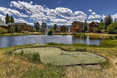 a large pond with a house in the background at 4 Mi to Granby Ranch Home with Mtn Views in Granby