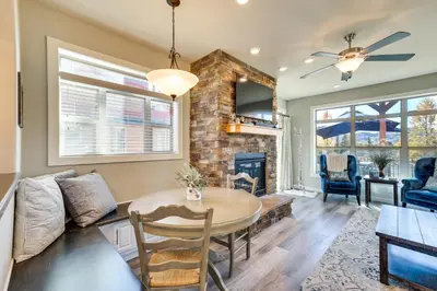 a living room with a table and a fireplace at 4 Mi to Granby Ranch Home with Mtn Views in Granby