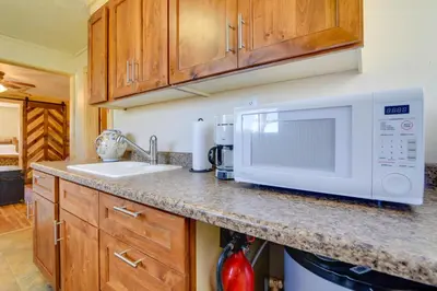 a kitchen counter with a microwave and a sink at Hiawatha Peaceful Living in Rocky Mtn Natl Park in Allenspark