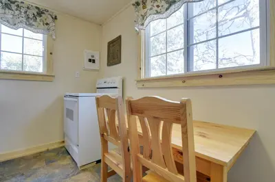 a kitchen with a wooden table and two chairs at Hiawatha Peaceful Living in Rocky Mtn Natl Park in Allenspark