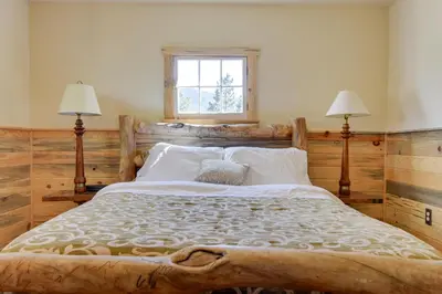a bedroom with a large bed with two lamps at Hiawatha Peaceful Living in Rocky Mtn Natl Park in Allenspark