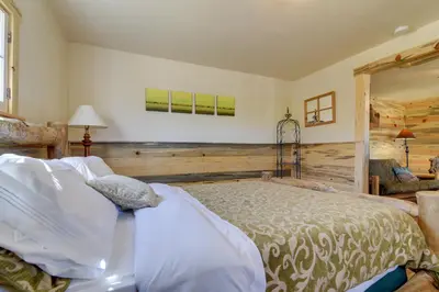 a bedroom with a bed and a chair in a room at Hiawatha Peaceful Living in Rocky Mtn Natl Park in Allenspark