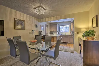 a dining room and kitchen with a glass table and chairs at Condo on Fraser River Less Than 4 Mi to Winter Park Resort in Winter Park