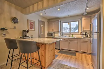 a kitchen with a counter and a refrigerator at Condo on Fraser River Less Than 4 Mi to Winter Park Resort in Winter Park