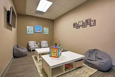 a waiting room with two tables and chairs and a sign at Condo on Fraser River Less Than 4 Mi to Winter Park Resort in Winter Park