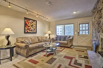 a living room with a couch and a table at Condo on Fraser River Less Than 4 Mi to Winter Park Resort in Winter Park