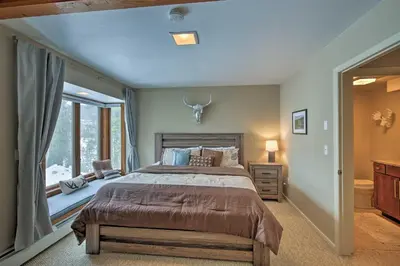 a bedroom with a large bed and a window at Luxurious Grand Lake Vacation Rental with Hot Tub! in Grand Lake