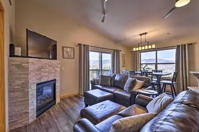 a living room with a couch and a fireplace at Newly Remodeled Mtn-View Condo in Silverthorne in Silverthorne