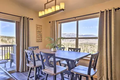 a dining room with a table and chairs and a large window at Newly Remodeled Mtn-View Condo in Silverthorne in Silverthorne