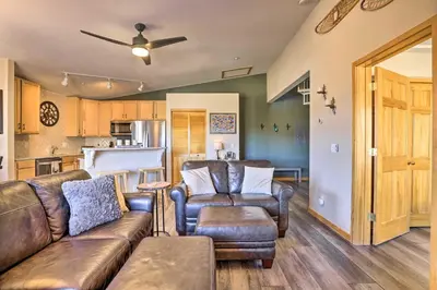 a living room with a couch and chairs and a kitchen at Newly Remodeled Mtn-View Condo in Silverthorne in Silverthorne