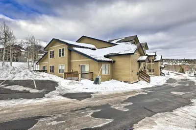 a house with snow on the side of a road at Newly Remodeled Mtn-View Condo in Silverthorne in Silverthorne
