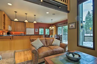 a living room with a couch and a table at Winter Park Cabin - Walk to Main Street and Downtown in Winter Park