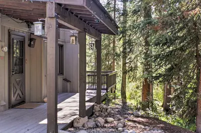 a front porch of a house with a deck at Winter Park Cabin - Walk to Main Street and Downtown in Winter Park