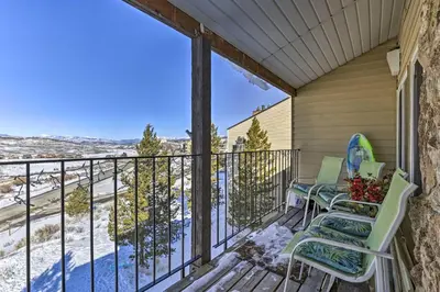 a balcony with two chairs and a view at Ski, Soak and Explore! Granby Getaway with Mtn Views in Granby