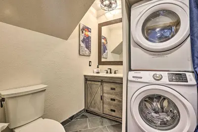 a bathroom with a washing machine and a toilet at Ski, Soak and Explore! Granby Getaway with Mtn Views in Granby