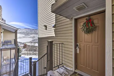 a door to a house with a christmas wreath on it at Ski, Soak and Explore! Granby Getaway with Mtn Views in Granby