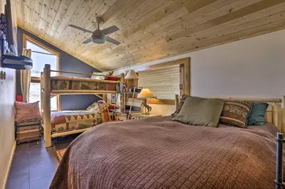 a bedroom with a bed and a ceiling fan at Ski, Soak and Explore! Granby Getaway with Mtn Views in Granby