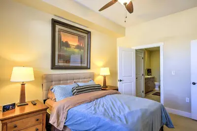 a bedroom with a bed and a picture on the wall at Ski-InandSki-Out Access Mtn-View Granby Condo! in Granby