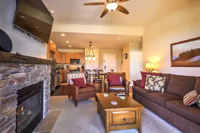 a living room with a couch and a fireplace at Ski-InandSki-Out Access Mtn-View Granby Condo! in Granby