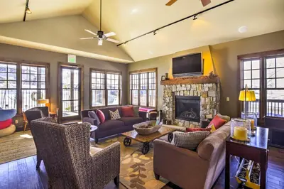 a living room with a couch and a fireplace at Ski-InandSki-Out Access Mtn-View Granby Condo! in Granby