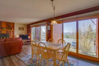 a dining room with a table and chairs and a couch at Silverthorne Condo Patio, Mtn Views, Pool Access! in Silverthorne