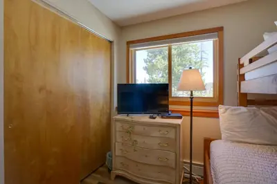a bedroom with a bed and a television on a dresser at Silverthorne Condo Patio, Mtn Views, Pool Access! in Silverthorne